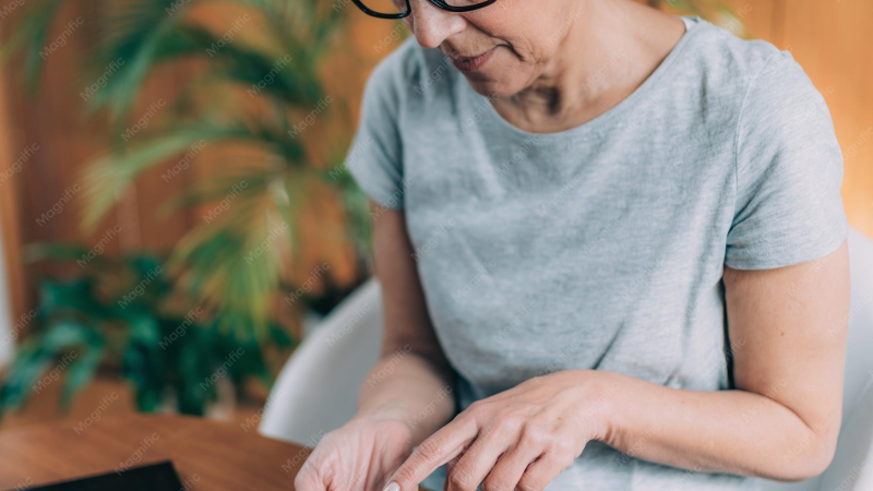 person waking up checking blood glucose monitor on nightstand