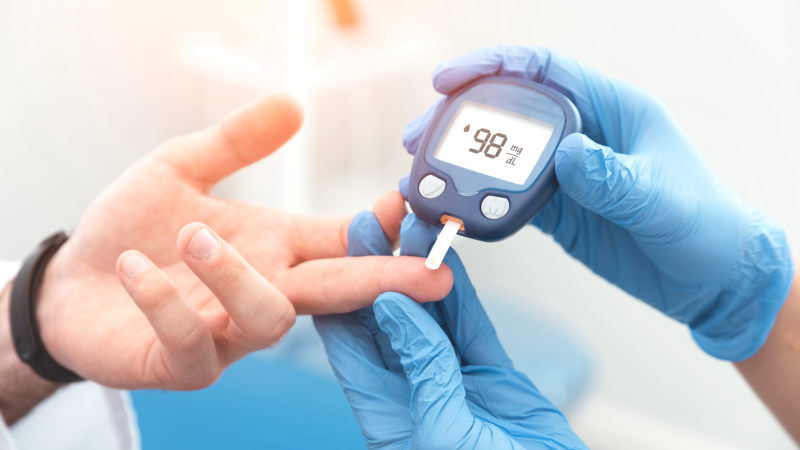 person testing blood glucose with a monitor