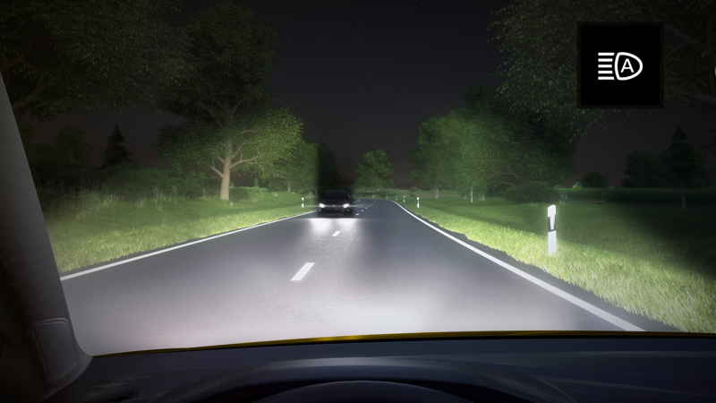 elderly person driving at night with headlights