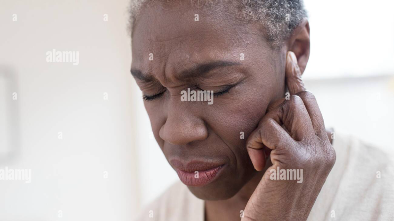 sudden hearing loss woman touching ear in morning