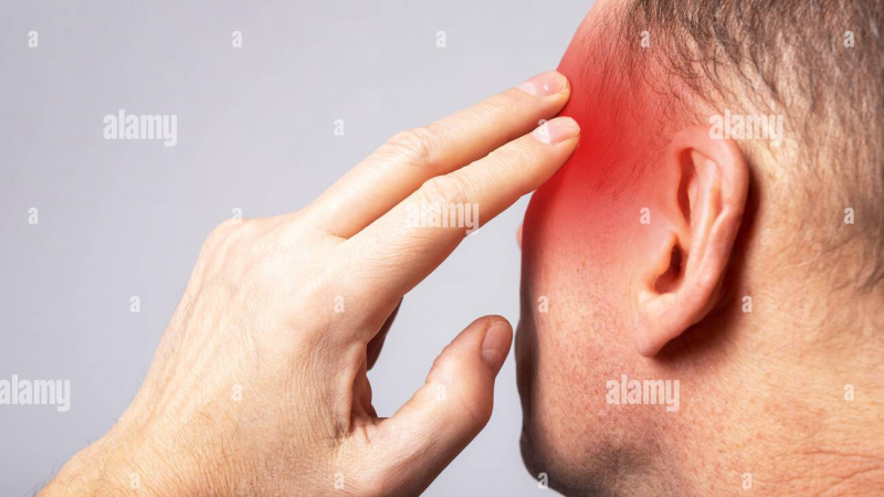 person holding head in frustration in quiet room