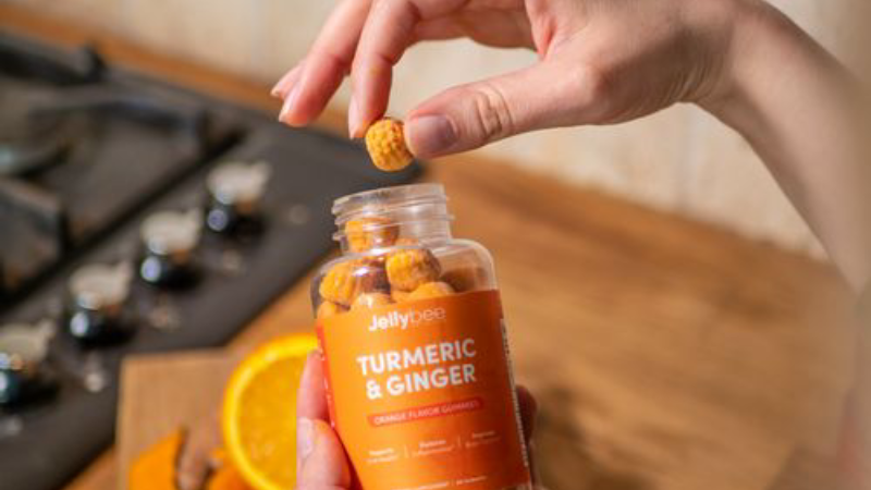 person holding a supplement bottle with natural ingredients listed