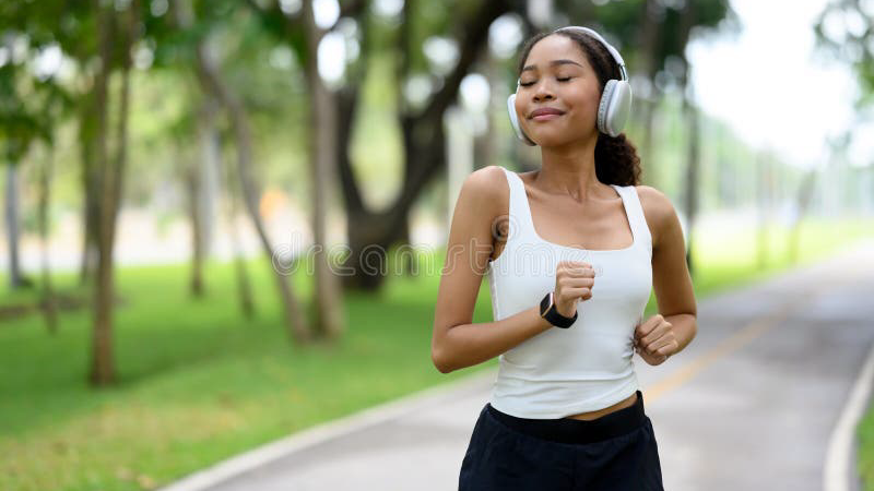 person walking outdoors in park, deep breathing