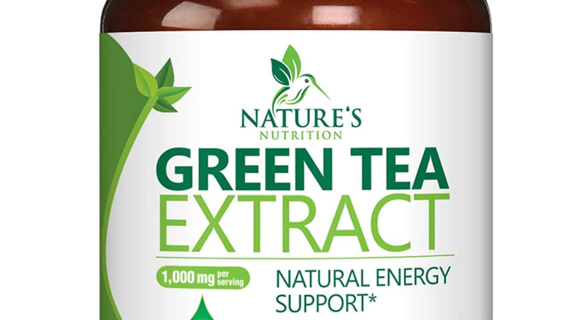 supplement ingredients capsules and green tea leaves on white background