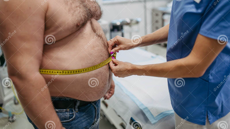 person struggling to measure waist with tape measure