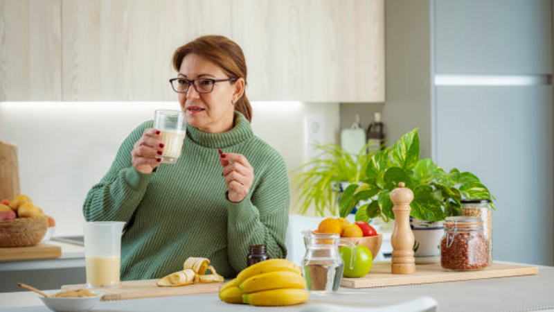 woman drinking a smoothie with supplements