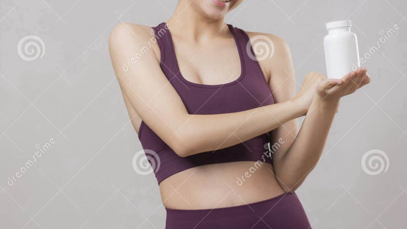 woman smiling, holding supplement bottle