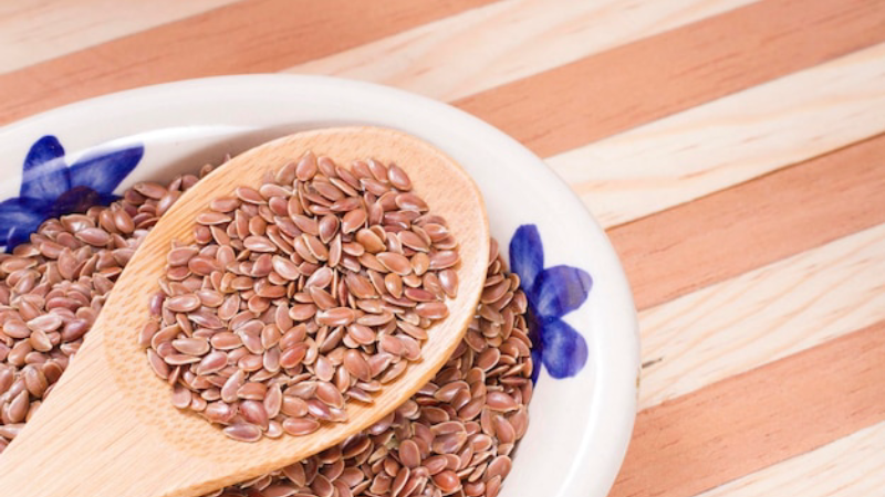 flaxseed and whole grains on a wooden table