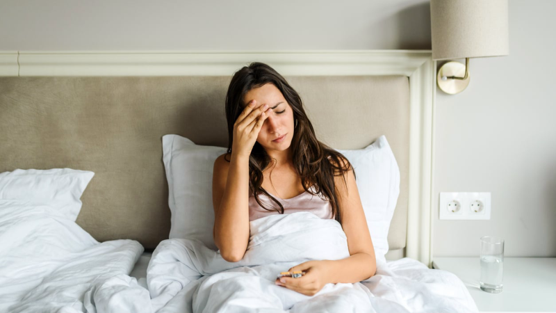 woman waking up sweaty in bed